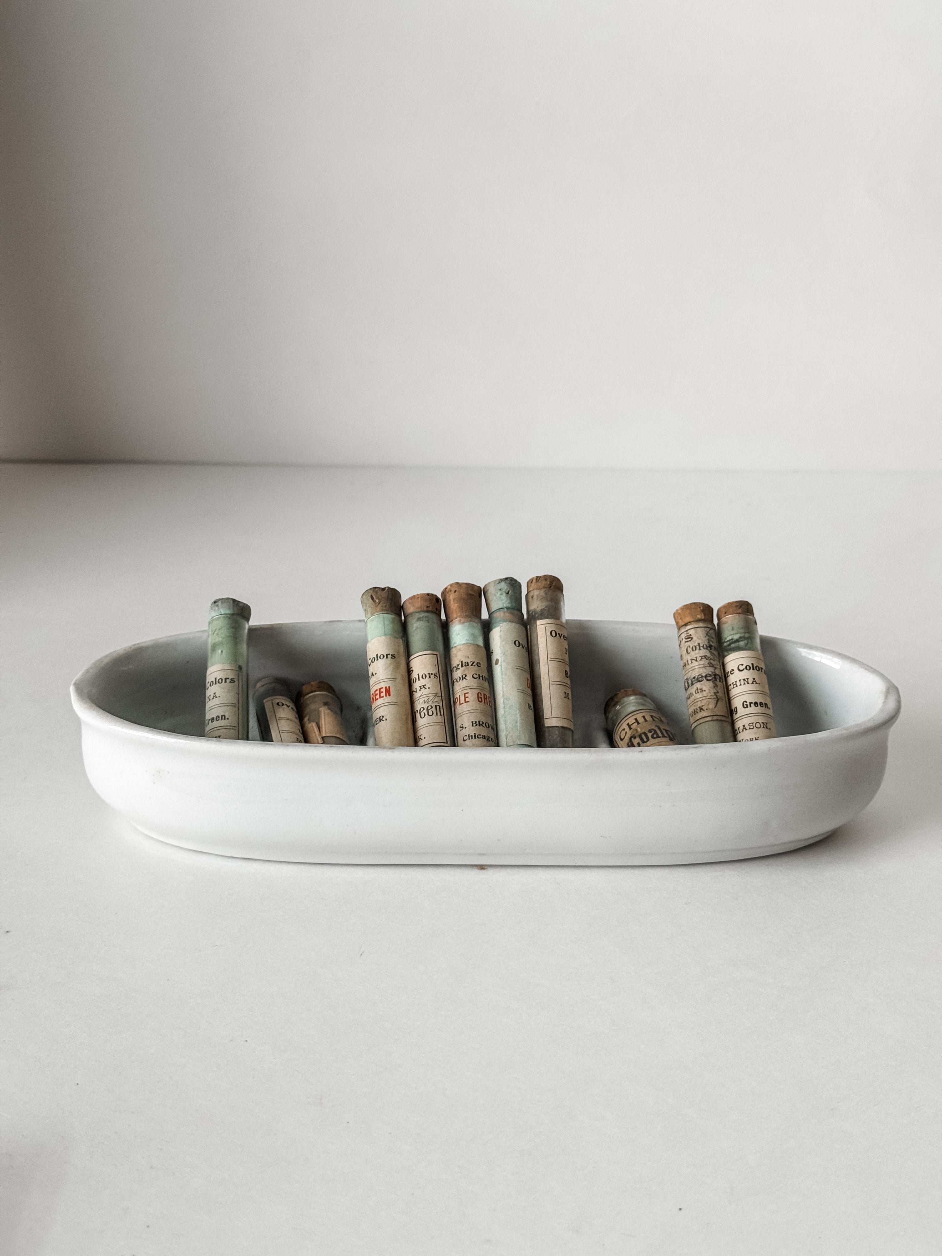 Set Of Glass Art Pigment Vials In Shades Of Green With Ironstone Vessel