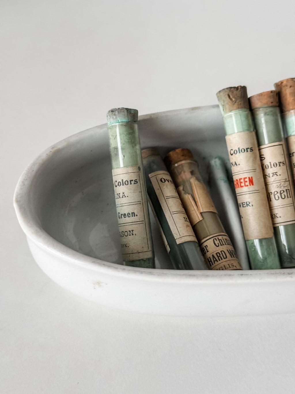 Set Of Glass Art Pigment Vials In Shades Of Green With Ironstone Vessel