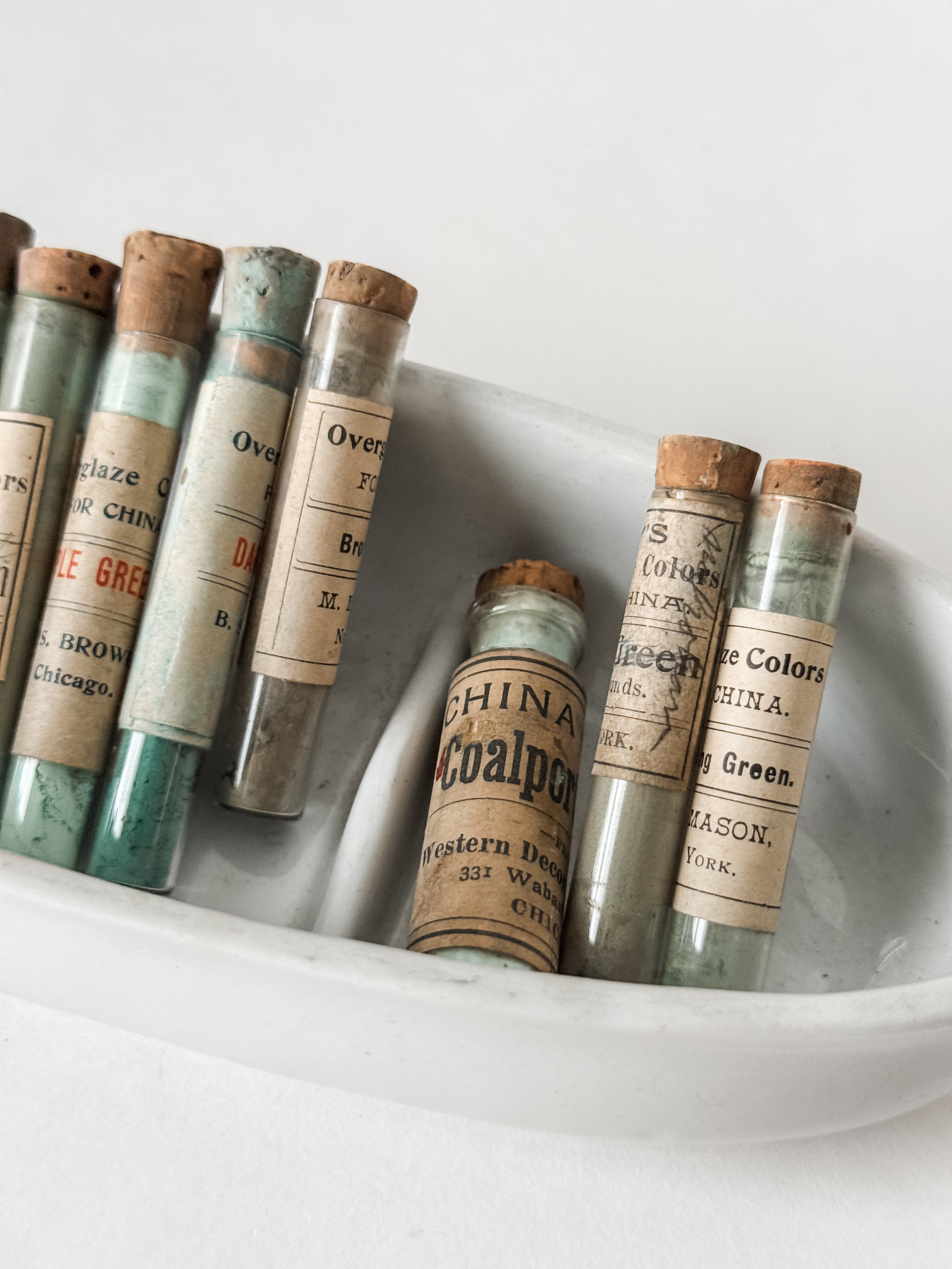 Set Of Glass Art Pigment Vials In Shades Of Green With Ironstone Vessel