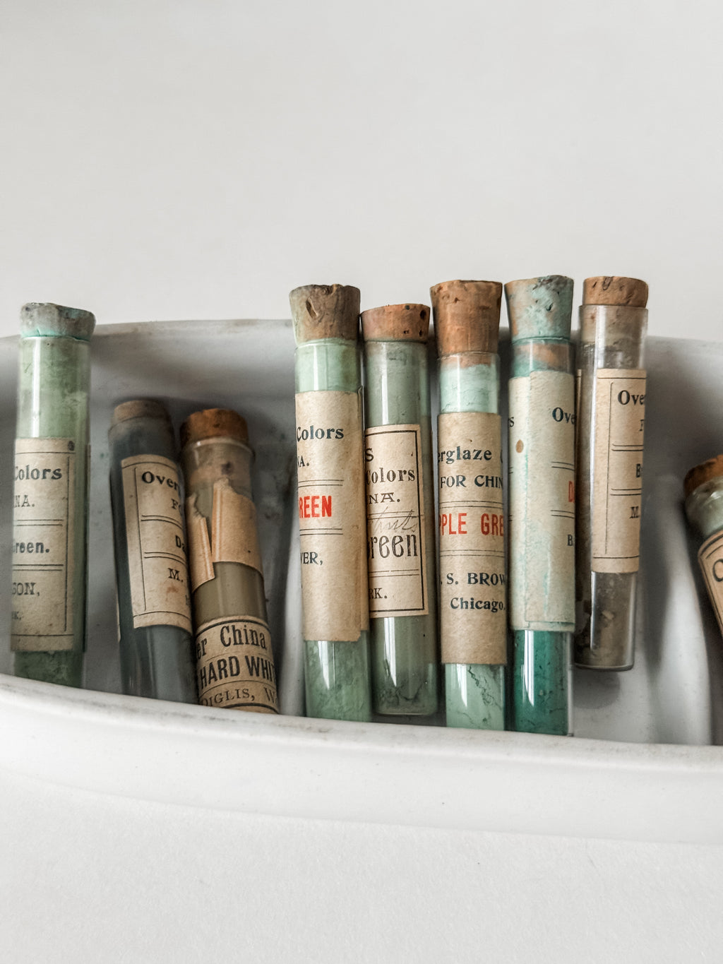 Set Of Glass Art Pigment Vials In Shades Of Green With Ironstone Vessel