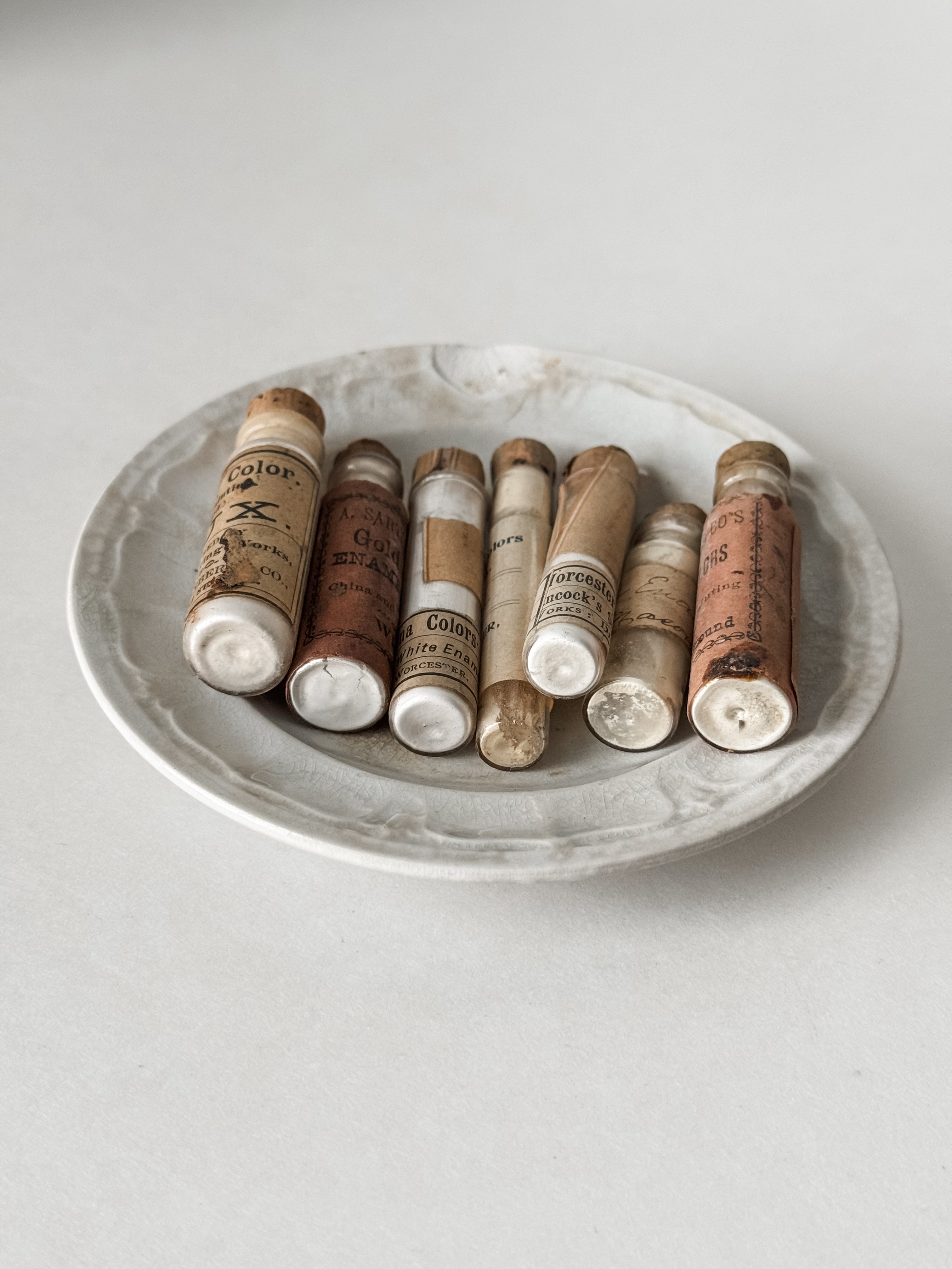 Set Of Glass Art Pigment Vials In Shades Of White With Antique Plate