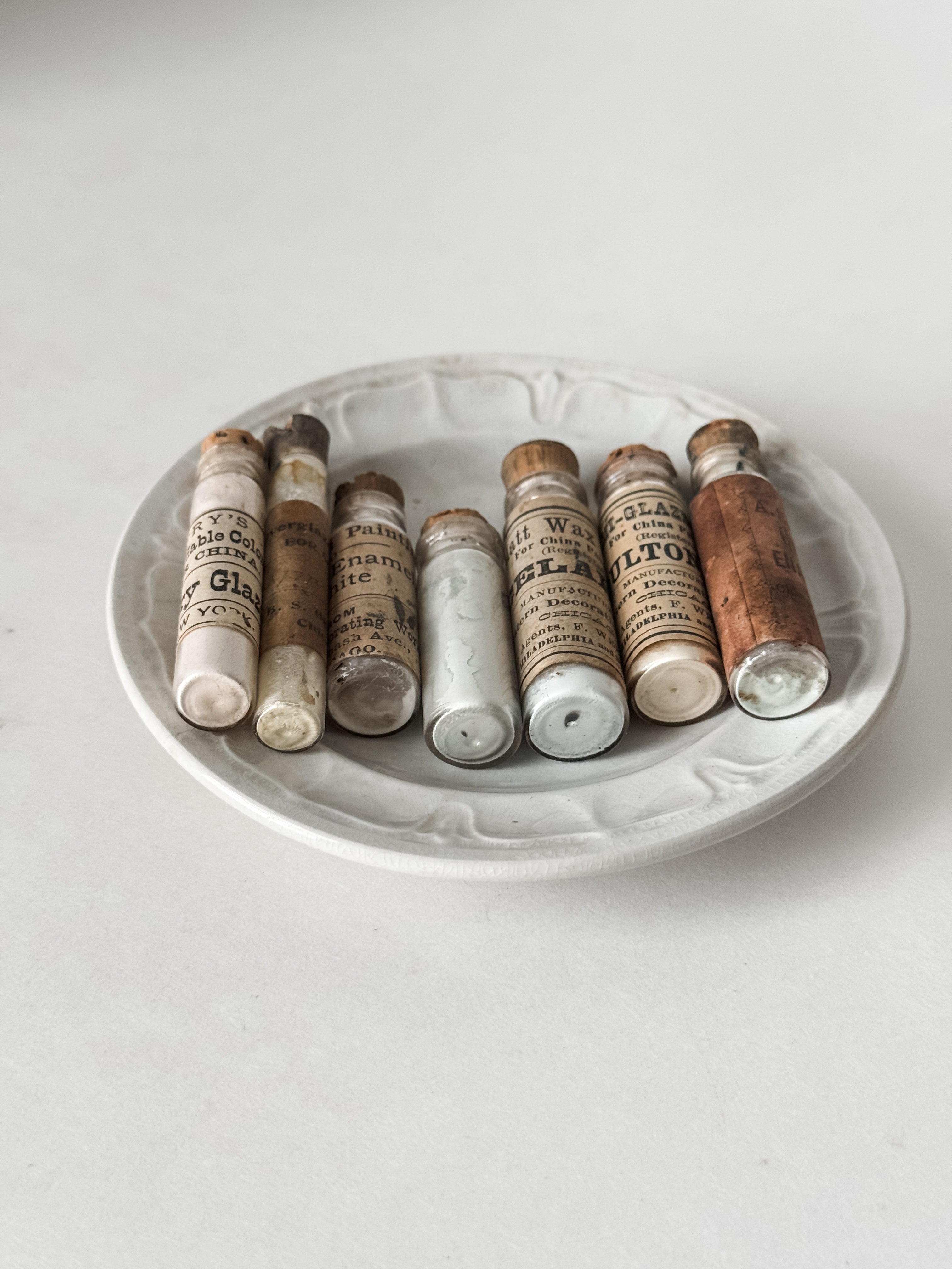 Set Of Glass Art Pigment Vials In Shades Of White With Antique Plate