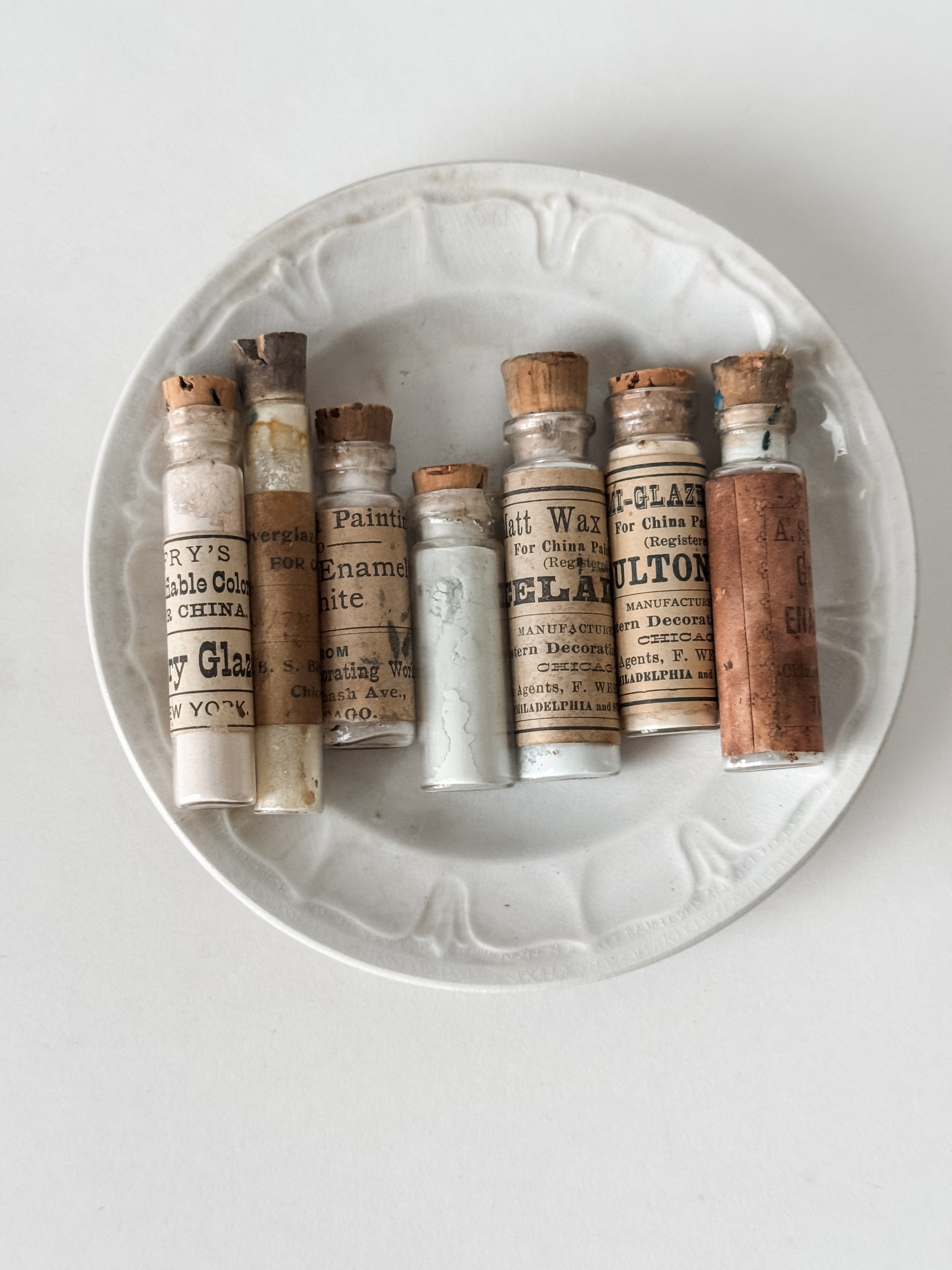 Set Of Glass Art Pigment Vials In Shades Of White With Antique Plate