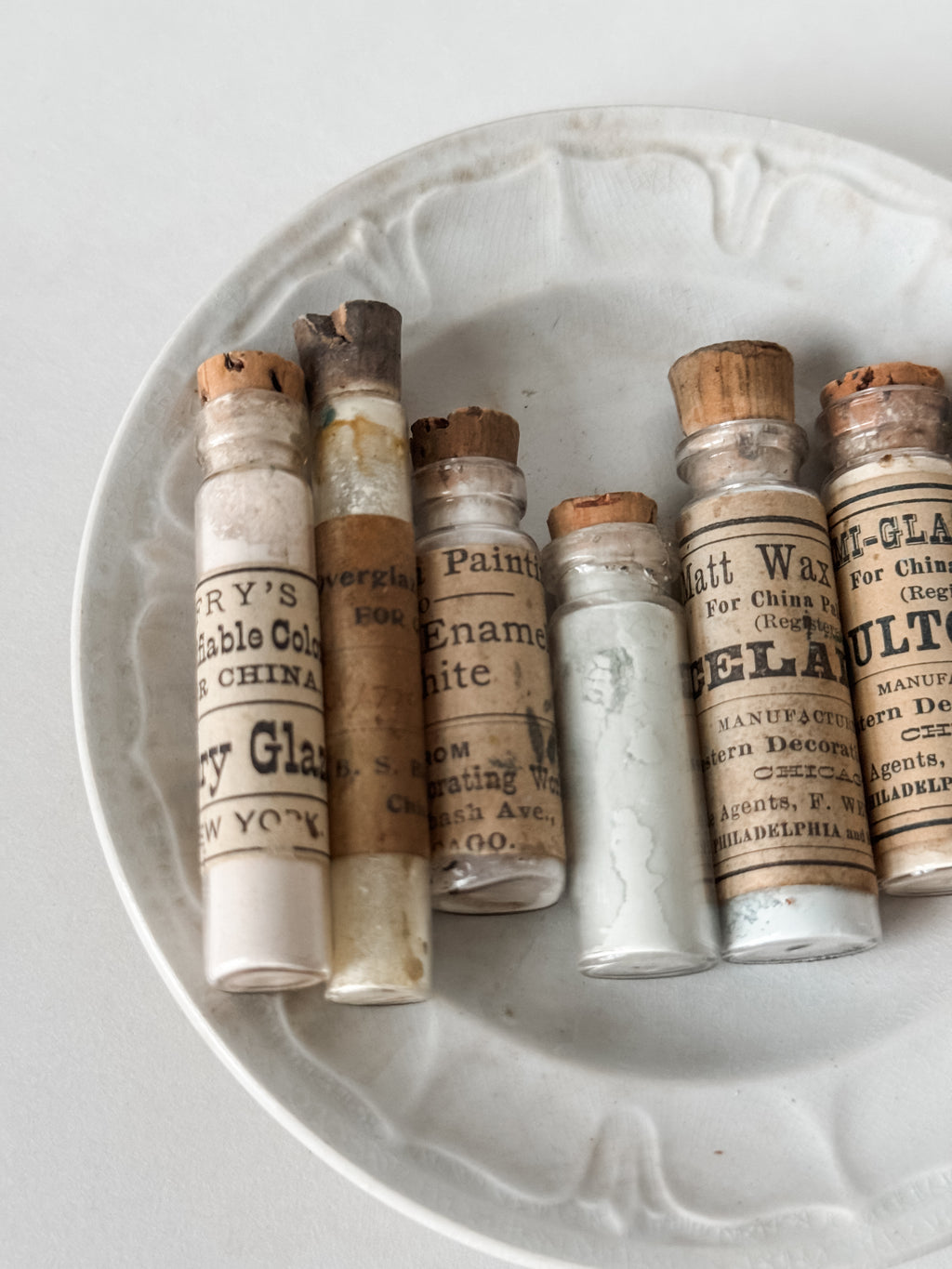 Set Of Glass Art Pigment Vials In Shades Of White With Antique Plate