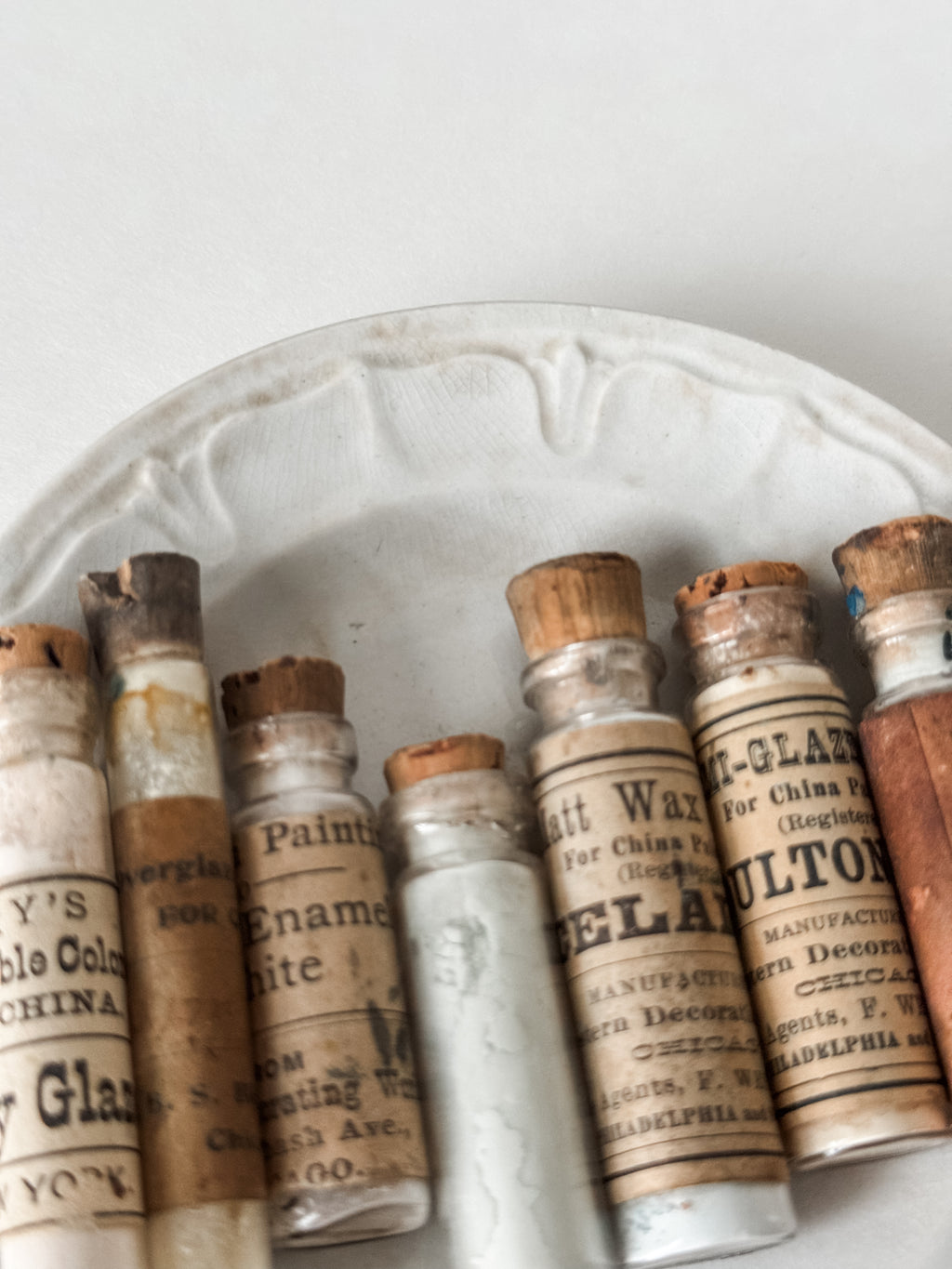 Set Of Glass Art Pigment Vials In Shades Of White With Antique Plate