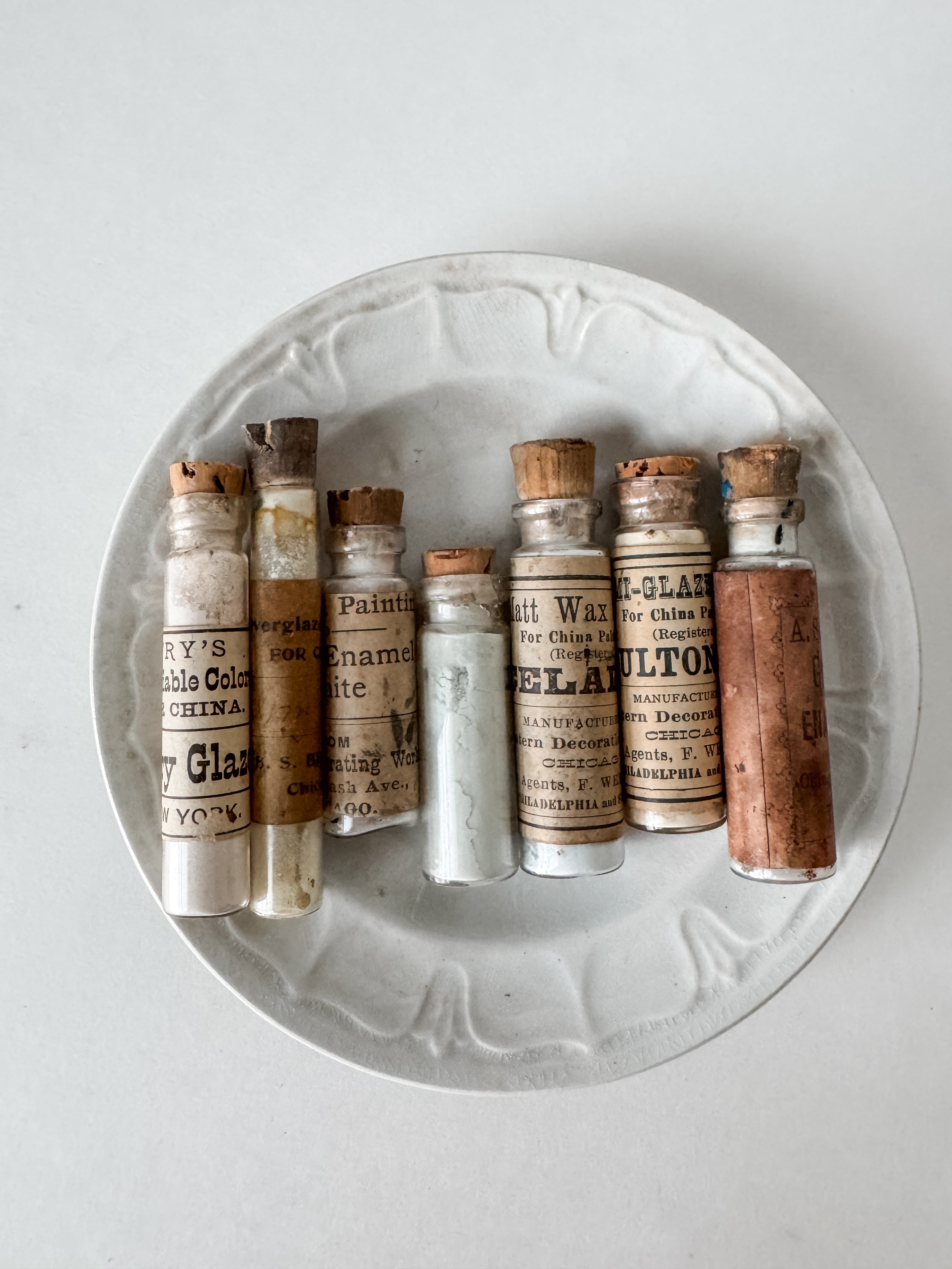 Set Of Glass Art Pigment Vials In Shades Of White With Antique Plate