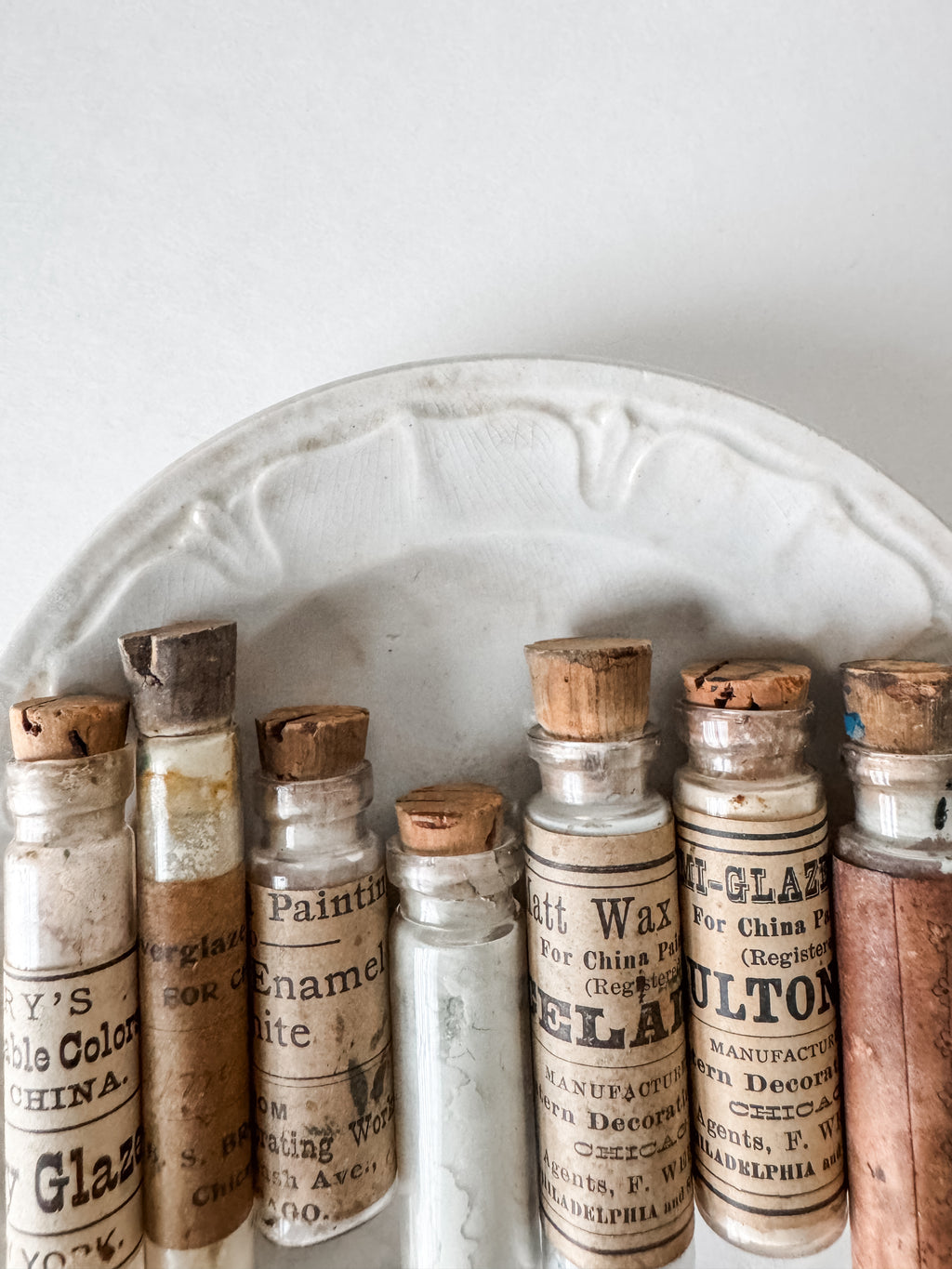 Set Of Glass Art Pigment Vials In Shades Of White With Antique Plate