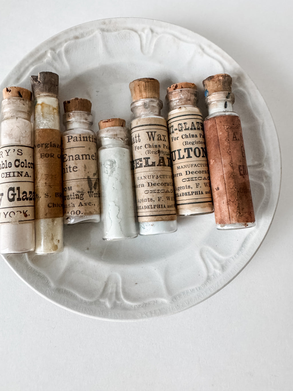 Set Of Glass Art Pigment Vials In Shades Of White With Antique Plate