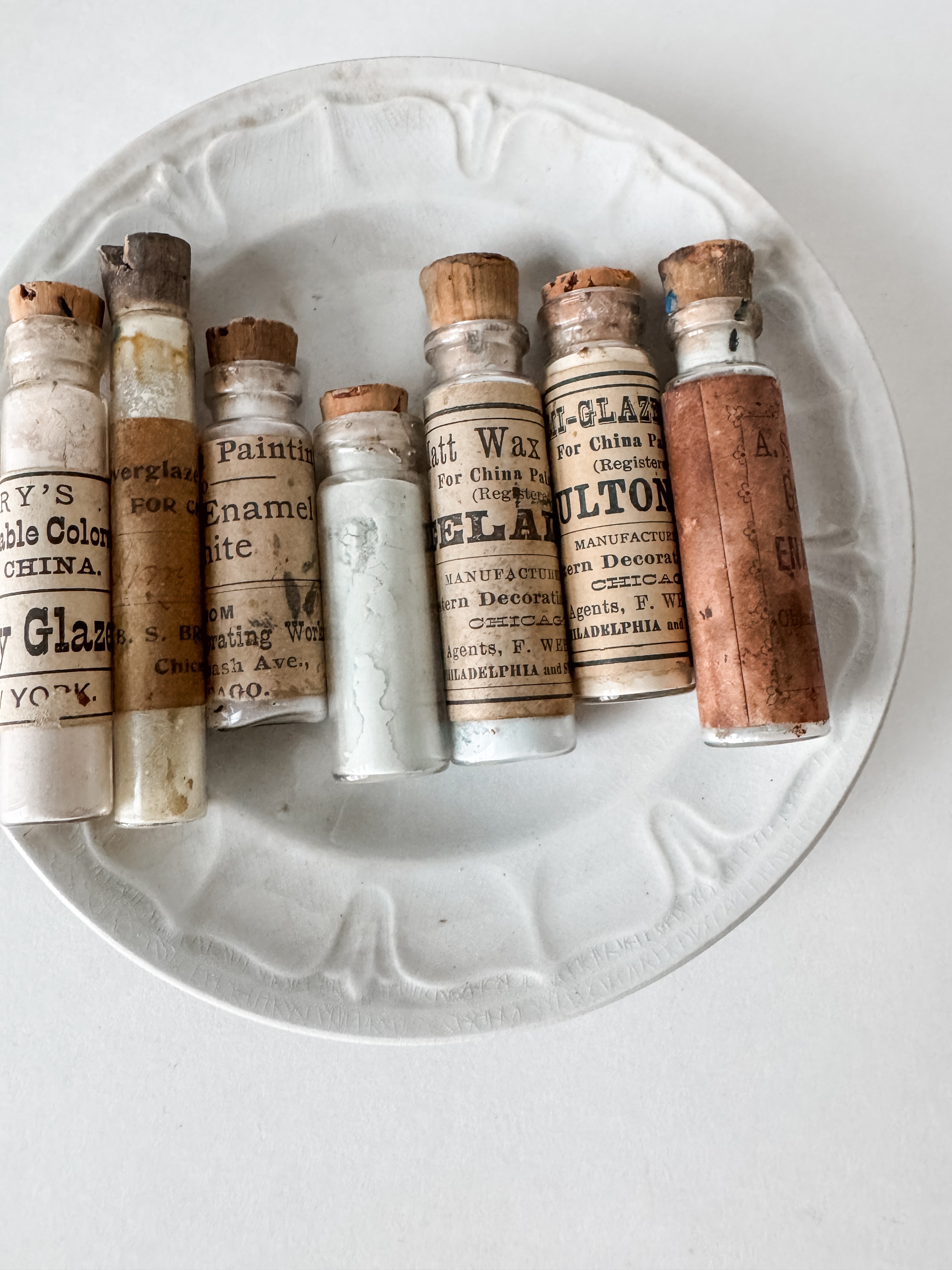 Set Of Glass Art Pigment Vials In Shades Of White With Antique Plate