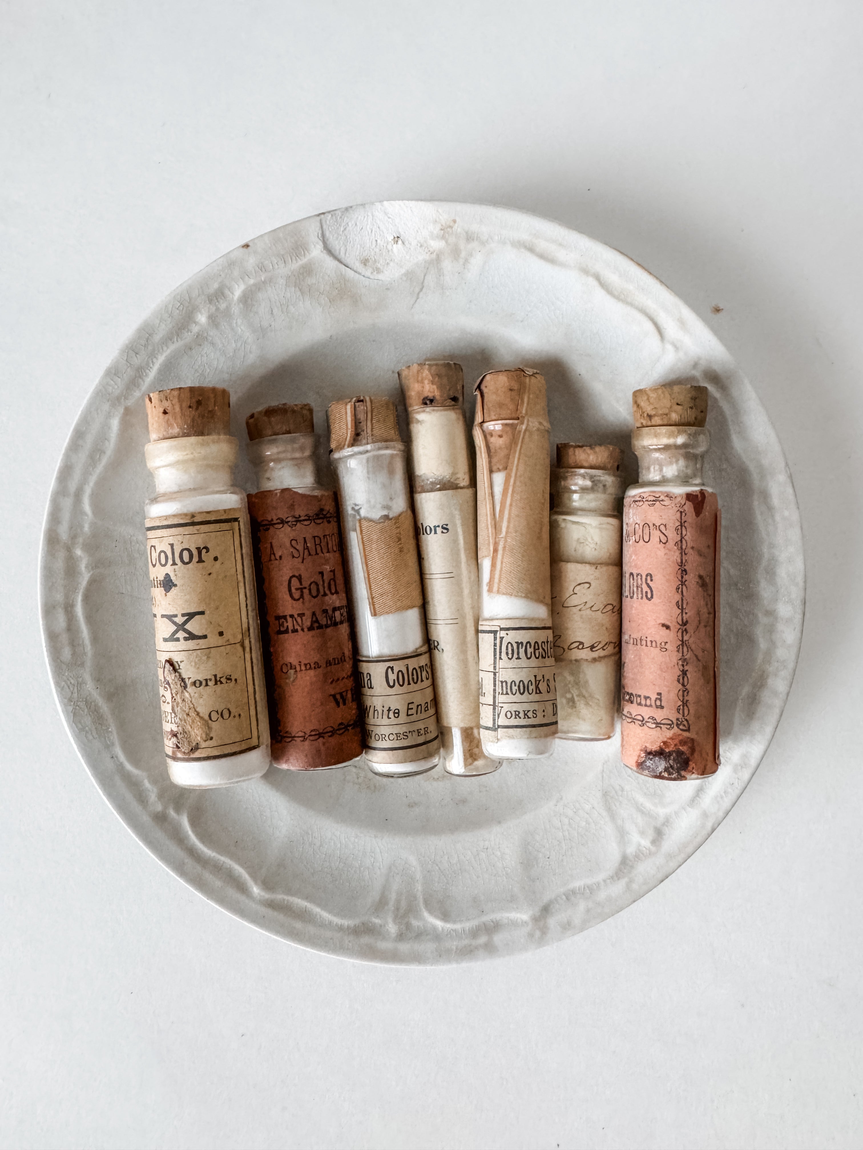 Set Of Glass Art Pigment Vials In Shades Of White With Antique Plate