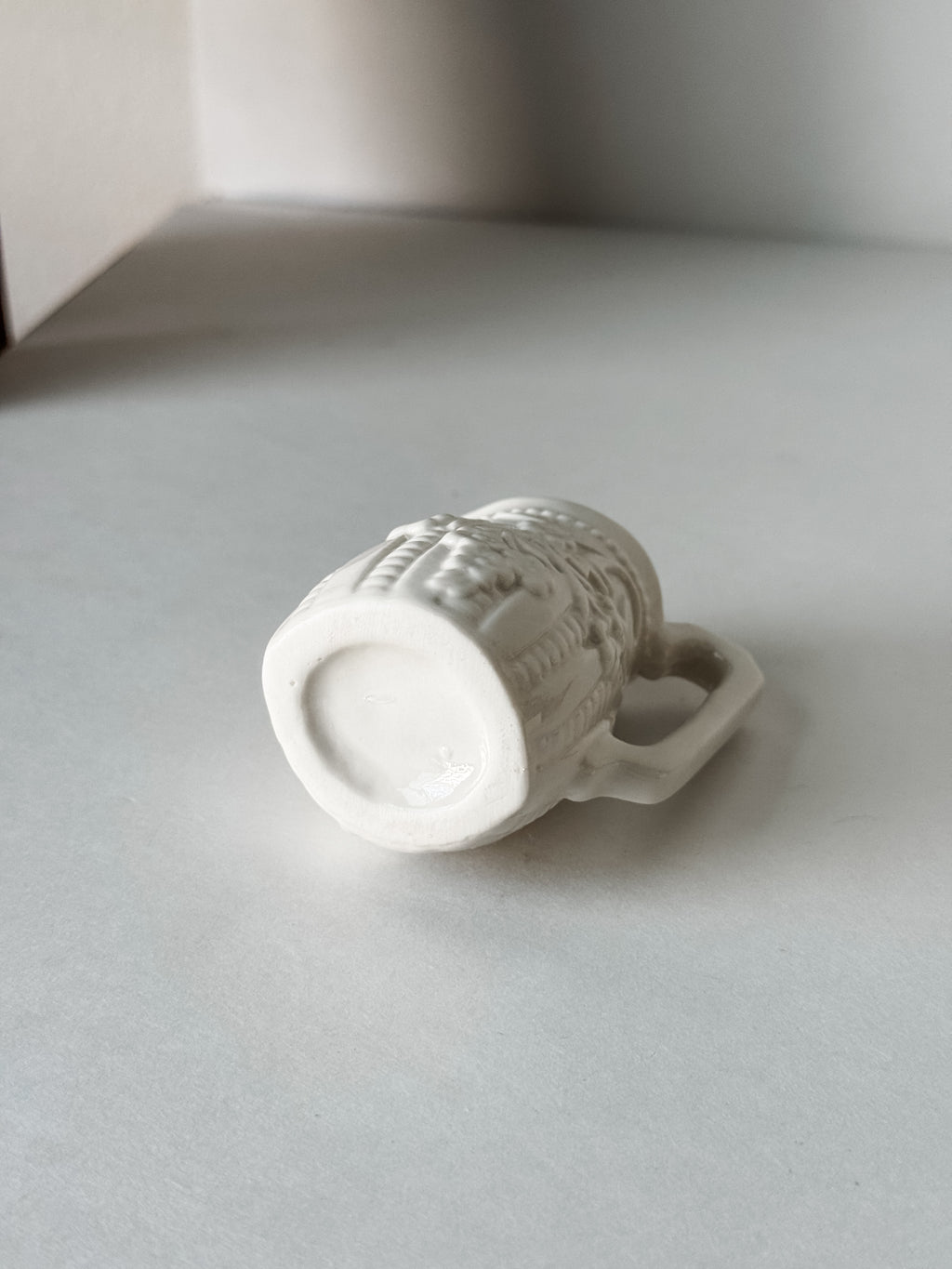 Small White Creamer With Handle And Raised Floral Details