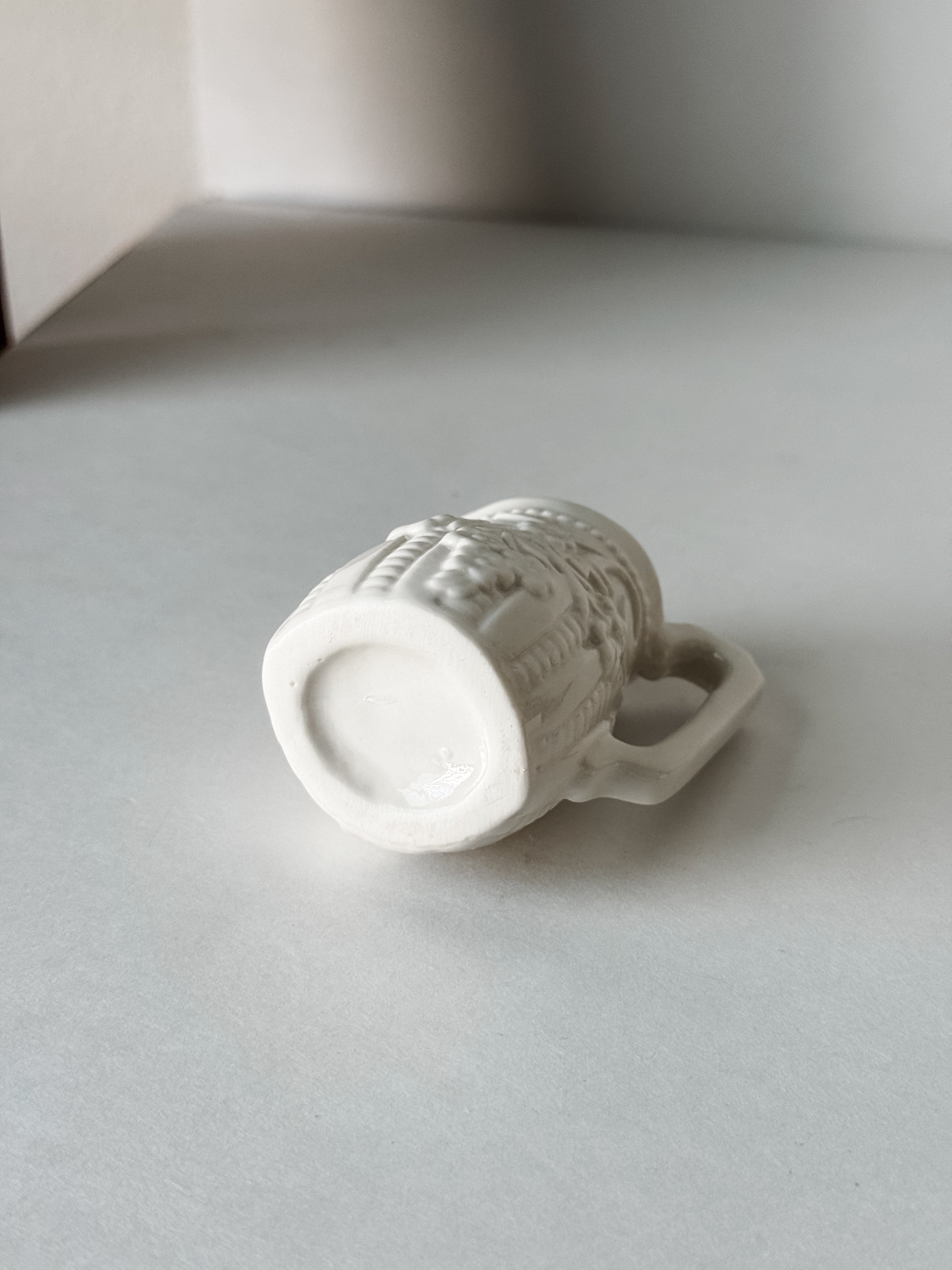 Small White Creamer With Handle And Raised Floral Details