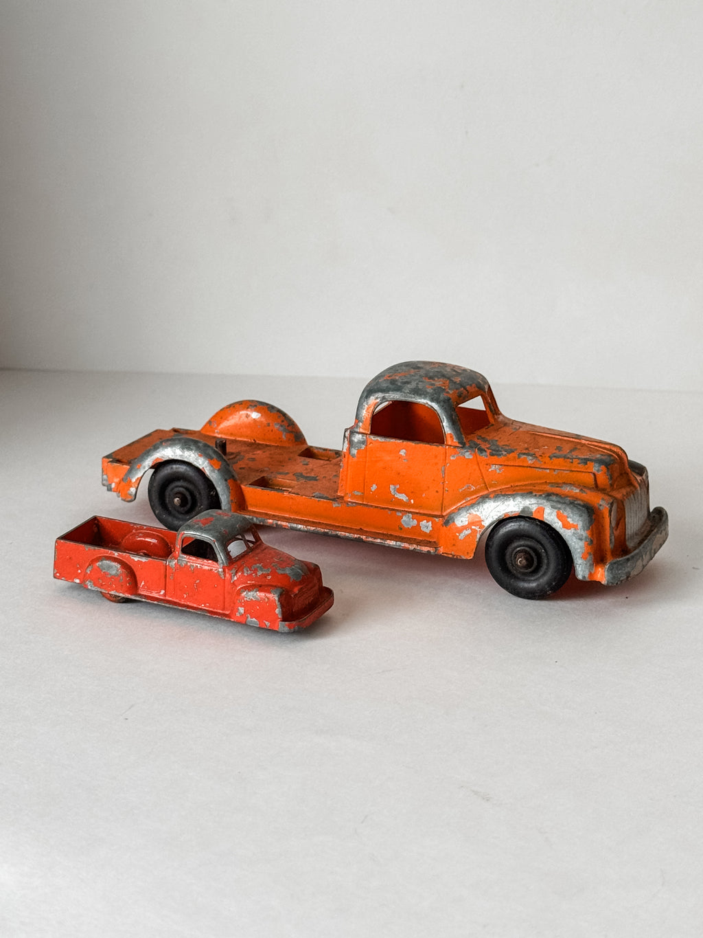 Pair Of Vintage Metal Chippy Orange Toy Trucks