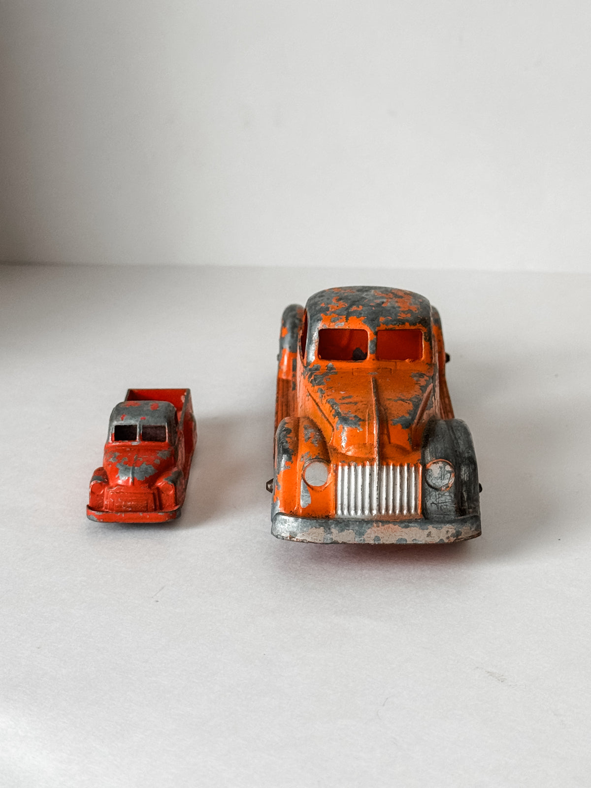 Pair Of Vintage Metal Chippy Orange Toy Trucks