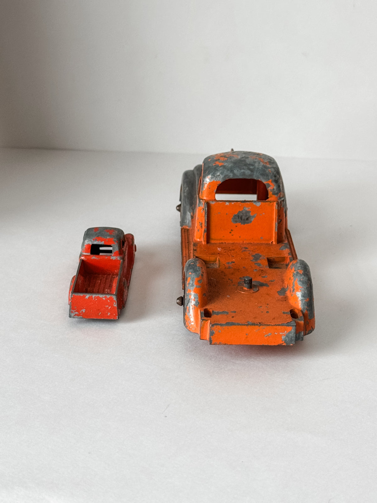 Pair Of Vintage Metal Chippy Orange Toy Trucks