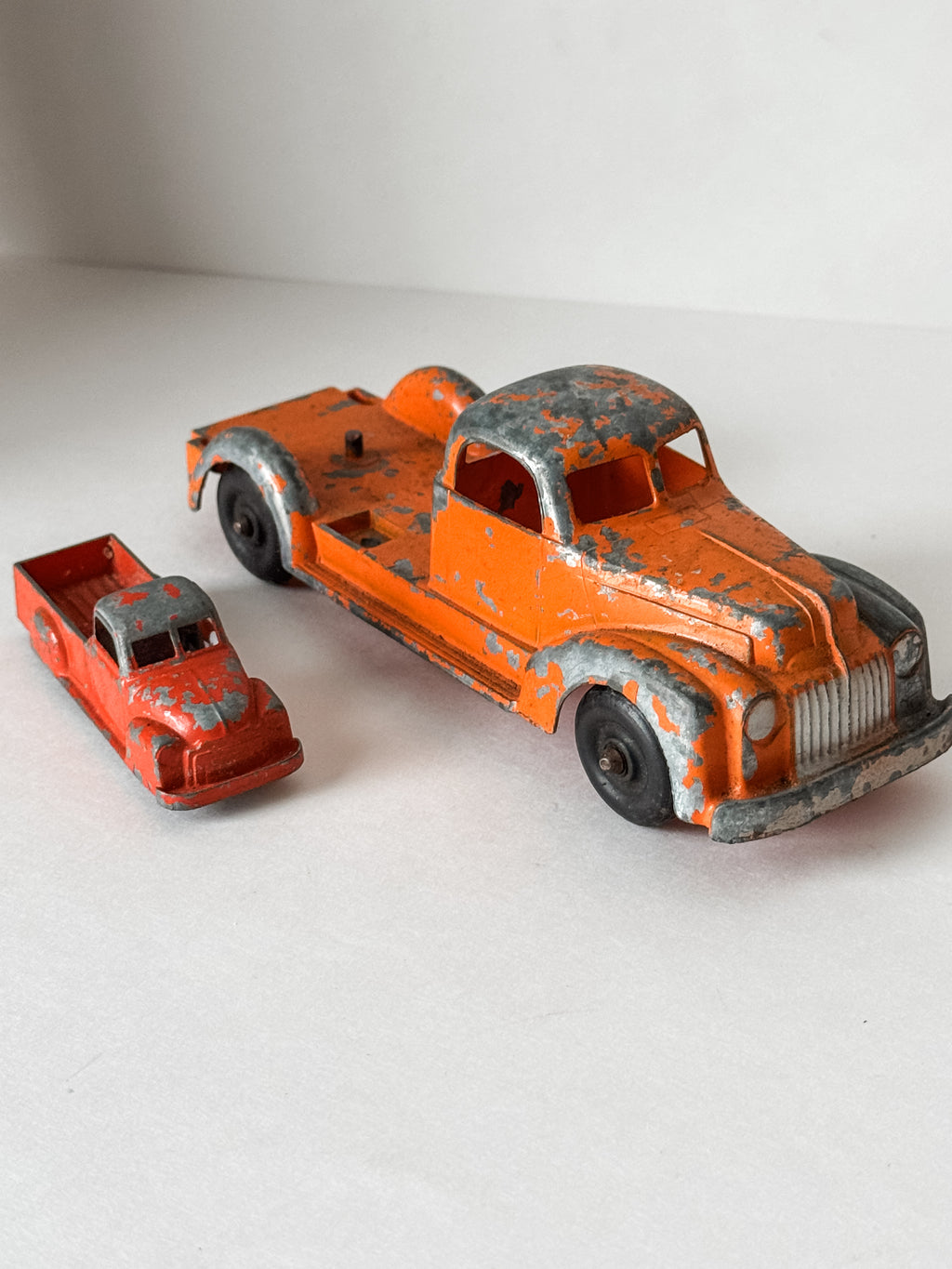 Pair Of Vintage Metal Chippy Orange Toy Trucks