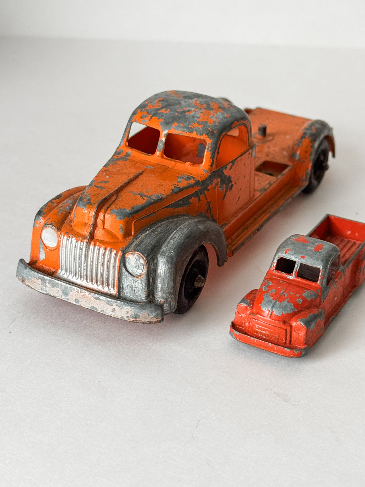 Pair Of Vintage Metal Chippy Orange Toy Trucks