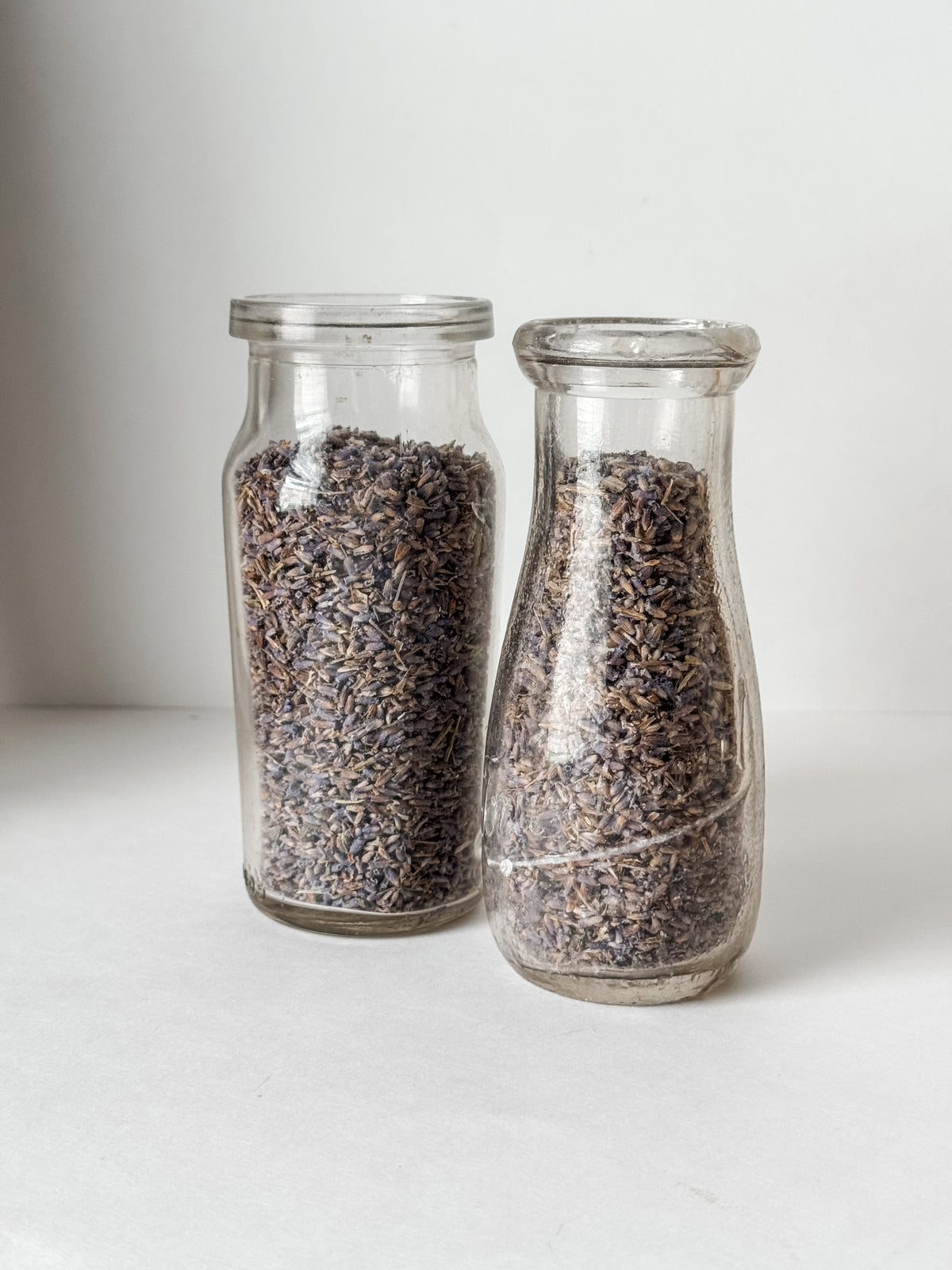 Pair Of Old Dairy Milk Bottles Filled With Loose Lavender