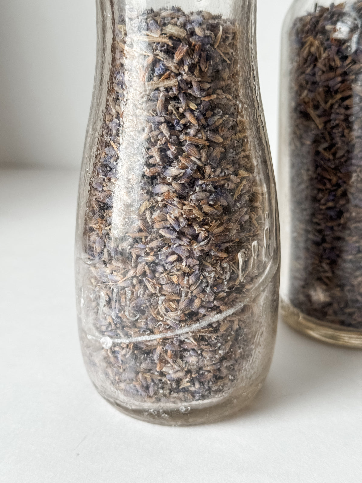 Pair Of Old Dairy Milk Bottles Filled With Loose Lavender