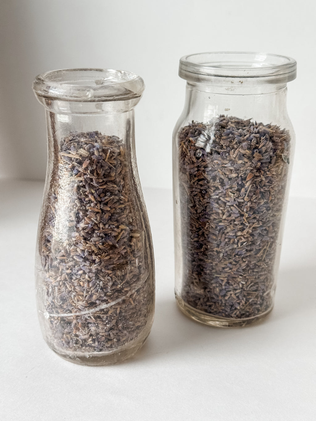Pair Of Old Dairy Milk Bottles Filled With Loose Lavender