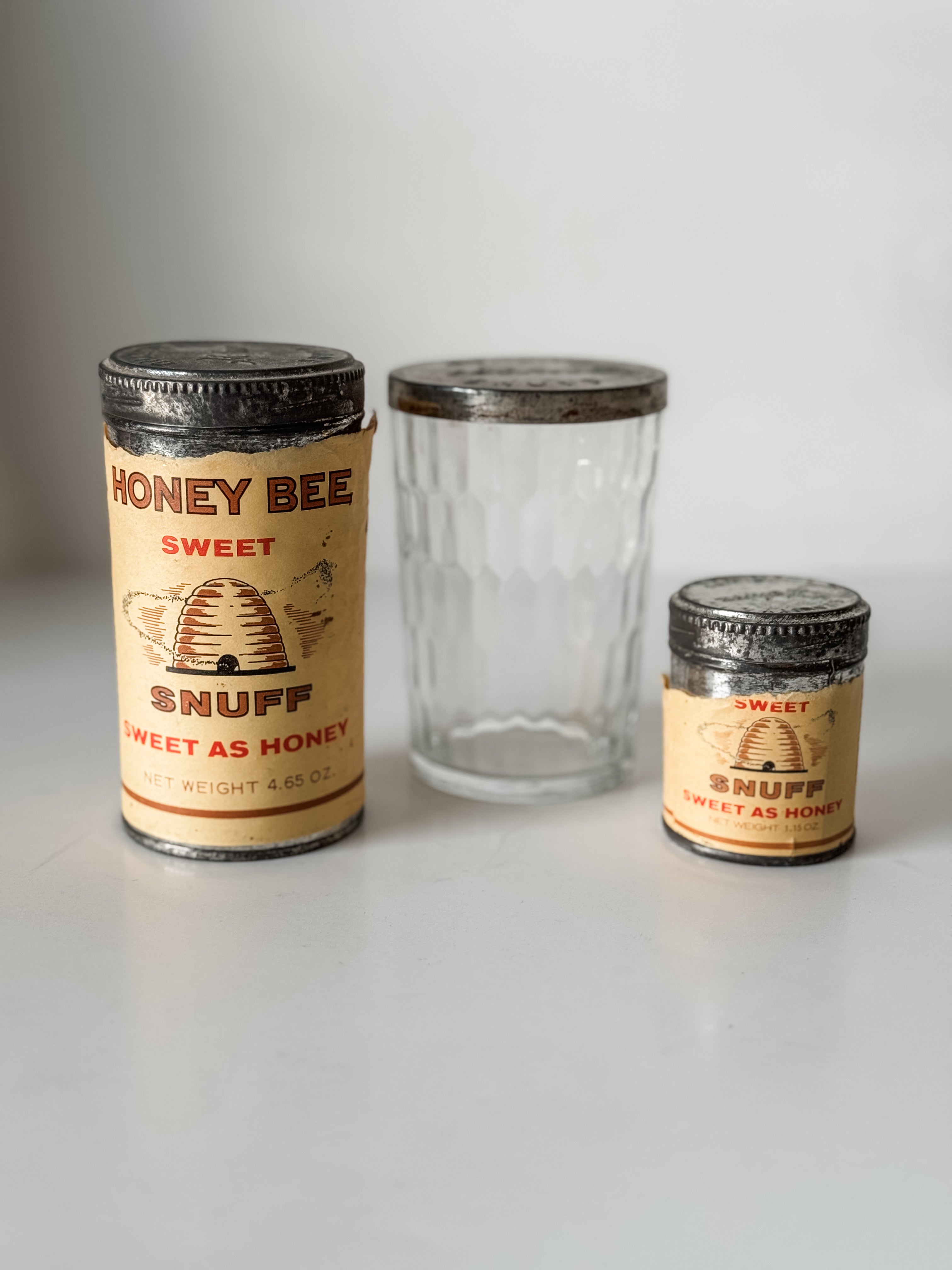 Collection Of Honey Bee Snuff Containers With Graphics