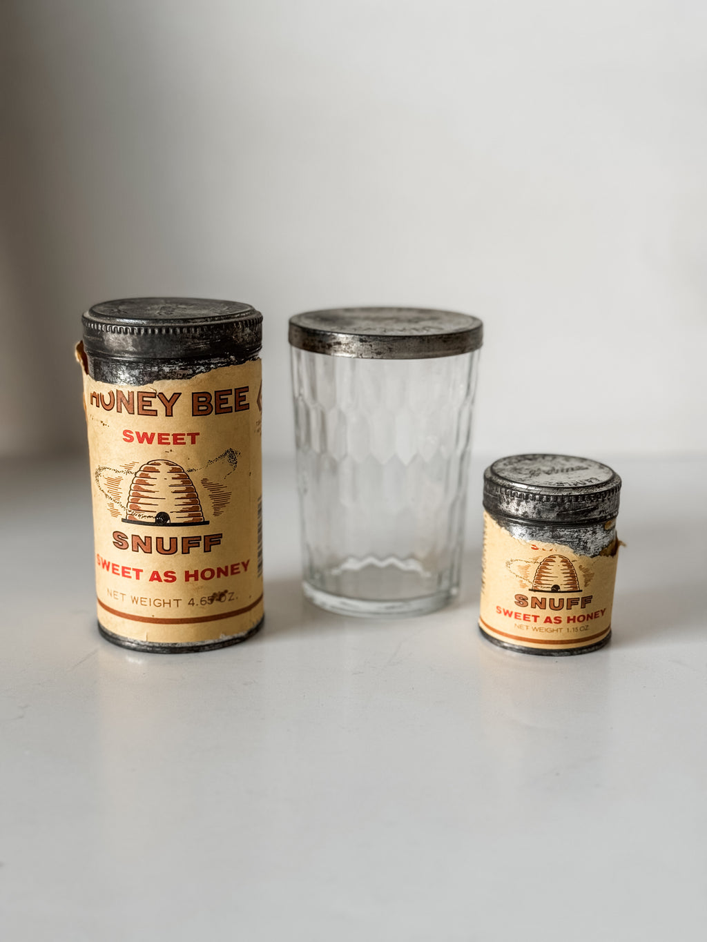 Collection Of Honey Bee Snuff Containers With Graphics