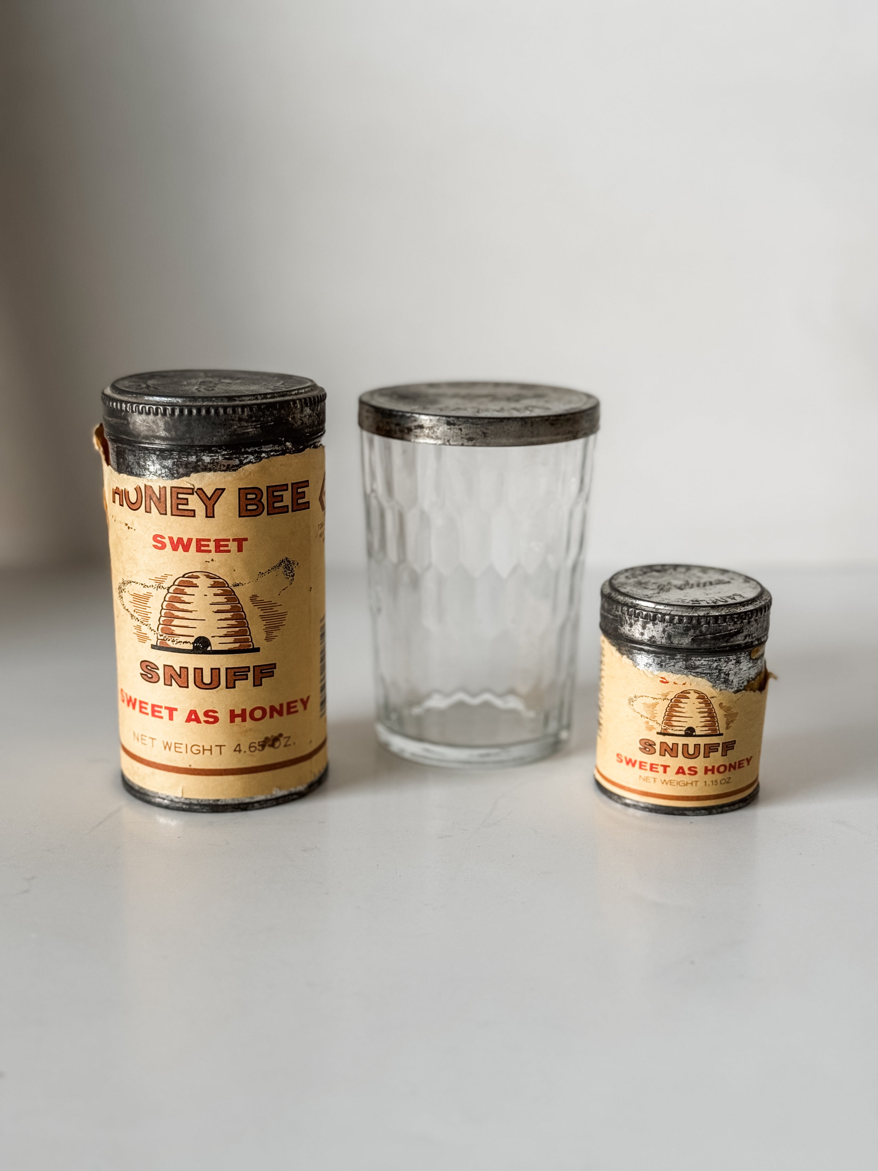 Collection Of Honey Bee Snuff Containers With Graphics